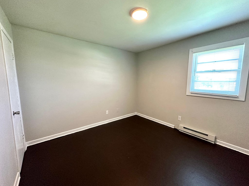 a empty room with white walls and a window