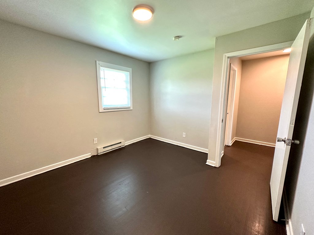 a empty room with a door and a window