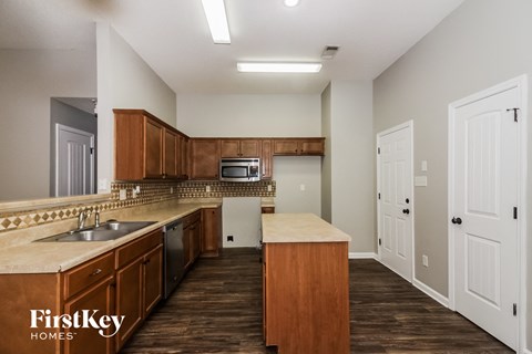 a kitchen with wooden cabinets and a counter top and a sink