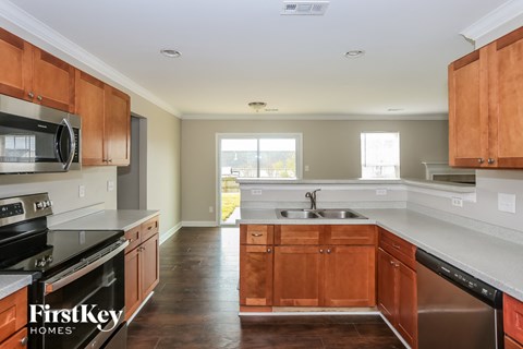 A kitchen with wooden cabinets and a stainless steel sink.