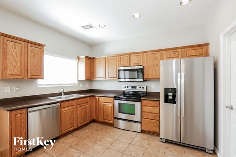 a kitchen with wooden cabinets and stainless steel appliances