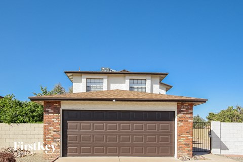 a house with a garage with a brown garage door