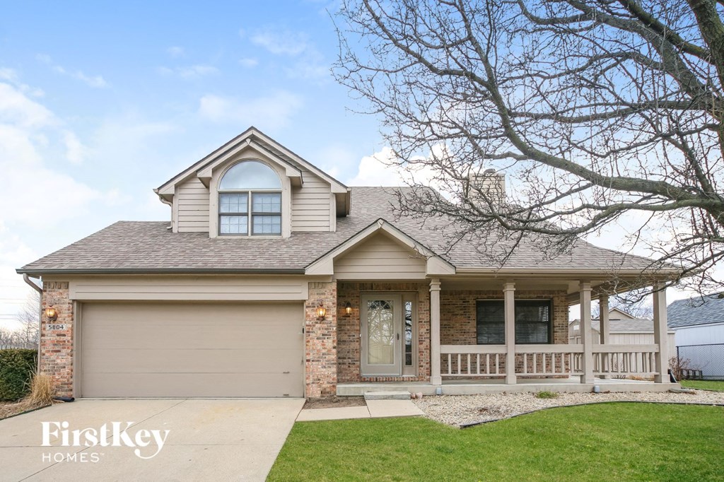 the front of a house with a porch