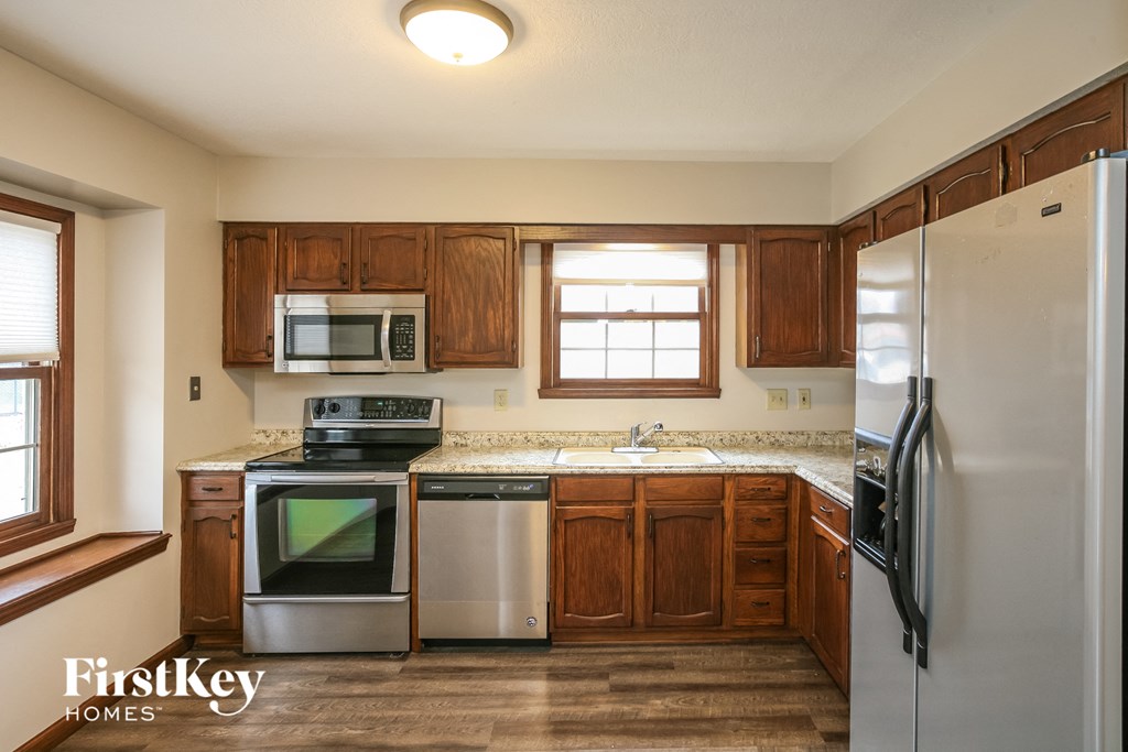 a kitchen with stainless steel appliances and wooden cabinets
