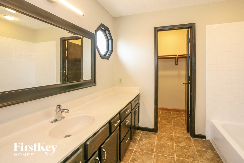 a bathroom with a sink and a mirror and a shower