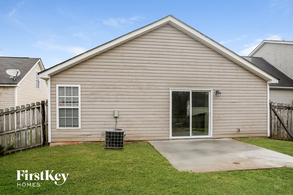 the outside of a house with a yard and a driveway