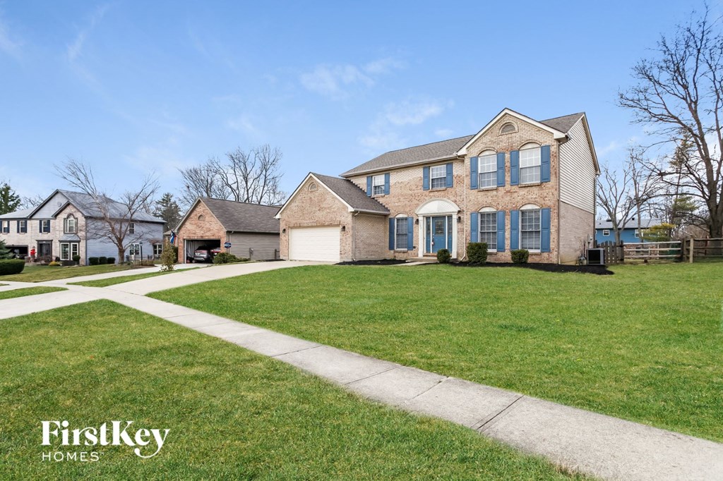 A large house with a lawn in front of it.