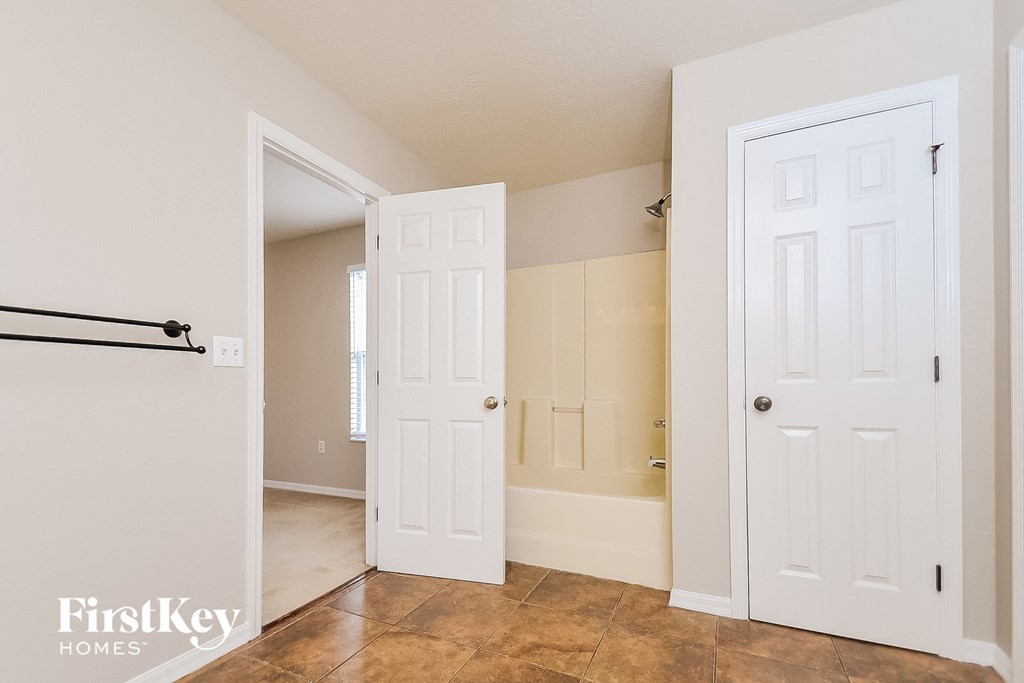 a bedroom with two closets and a door to a bathroom