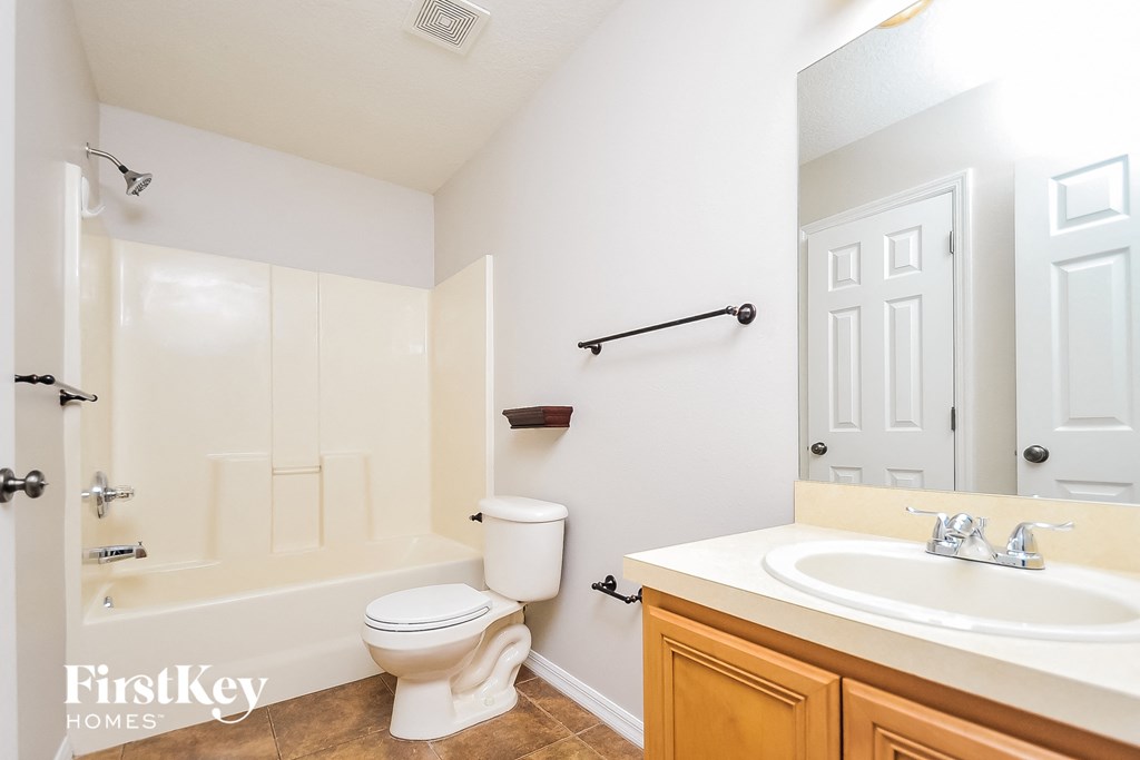 a bathroom with a toilet and a sink and a shower