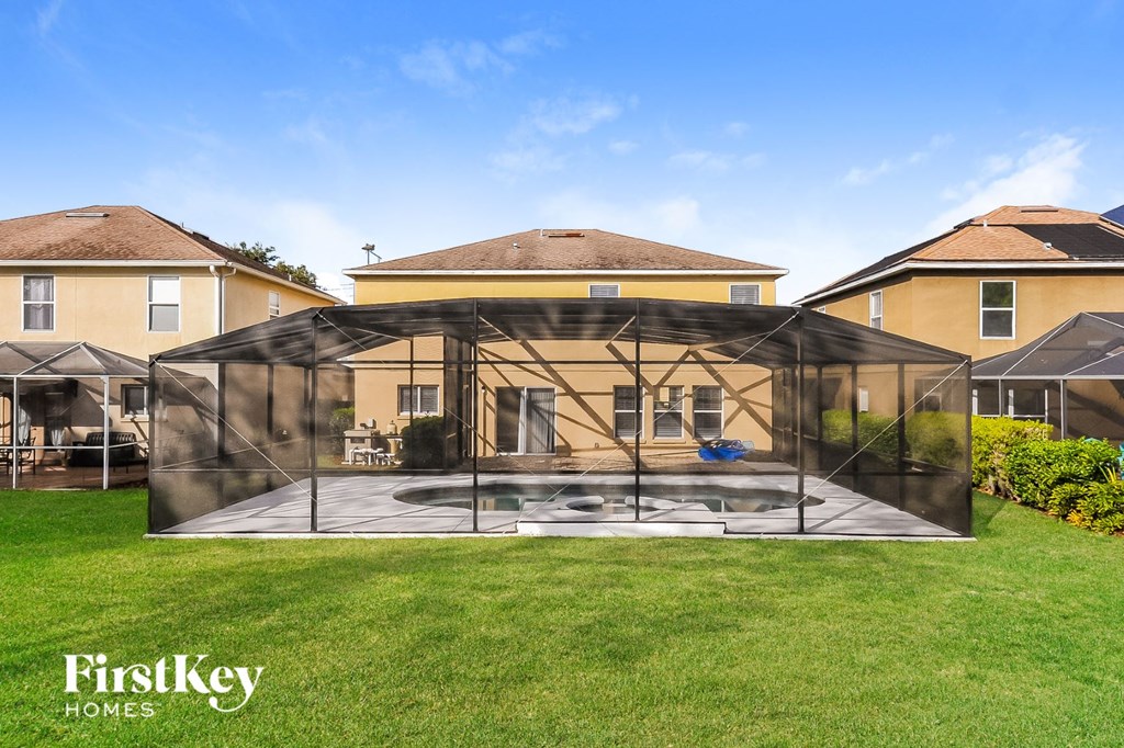 a greenhouse in the backyard of a house