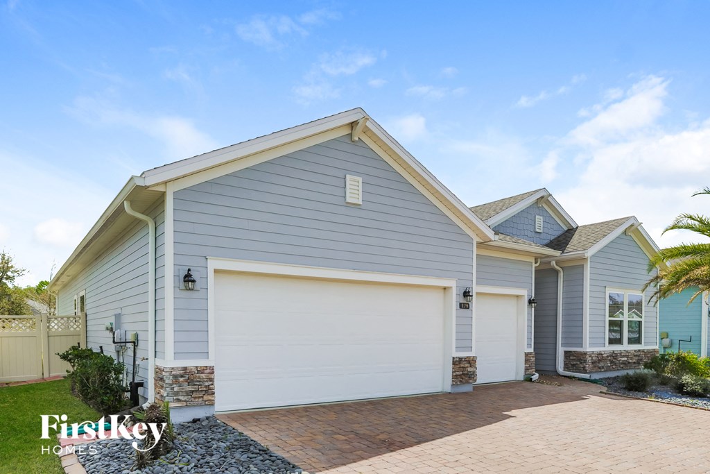 a blue house with a white garage door