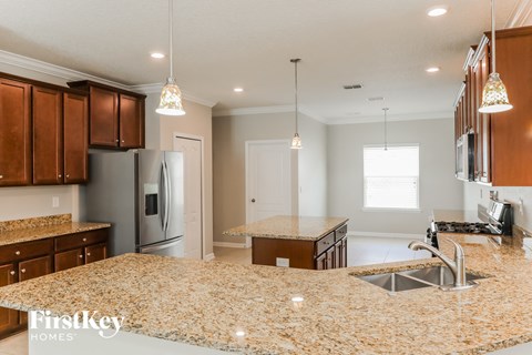 a kitchen with granite counter tops and a large island