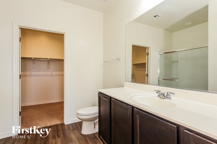 a bathroom with a sink and a toilet and a mirror