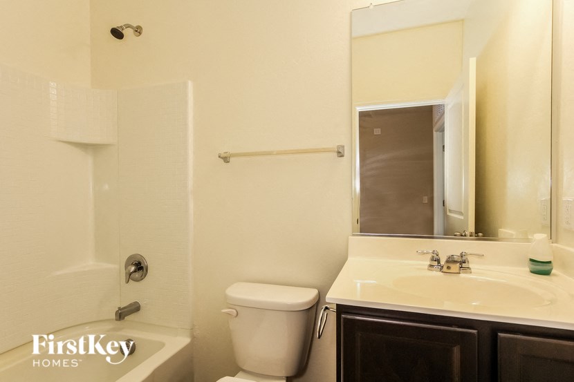 a bathroom with a toilet and a sink and a mirror