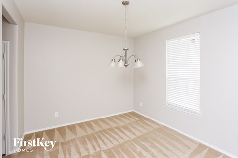 a empty room with a chandelier and a window