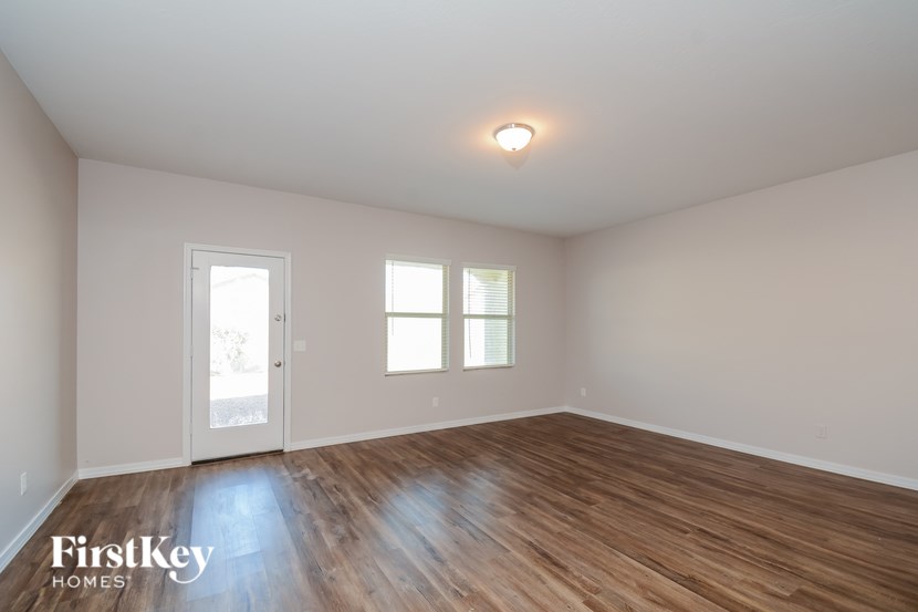 A room with wooden floors and a white door.