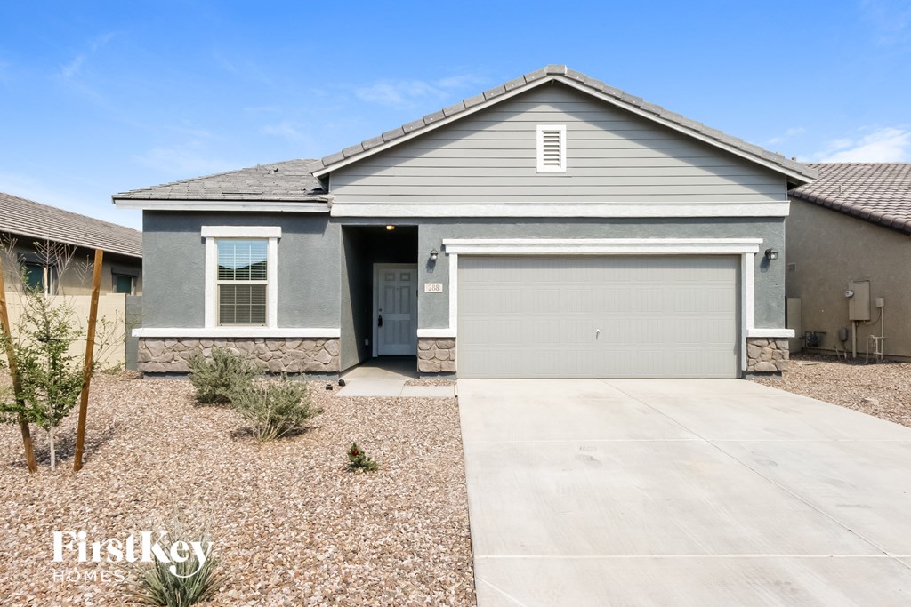 A house with a grey garage door is for sale.