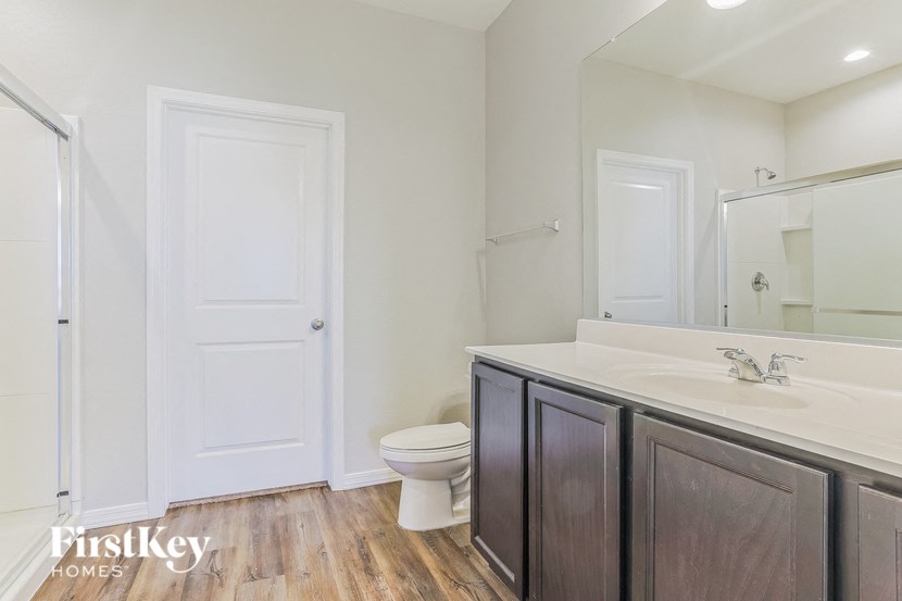 a bathroom with a toilet and a sink and a mirror