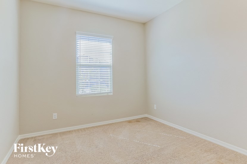 a empty room with white walls and a window