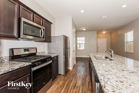 a kitchen with granite counter tops and stainless steel appliances