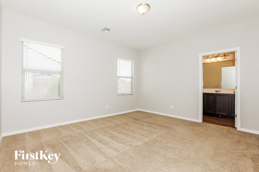 an empty living room with a sink and a mirror