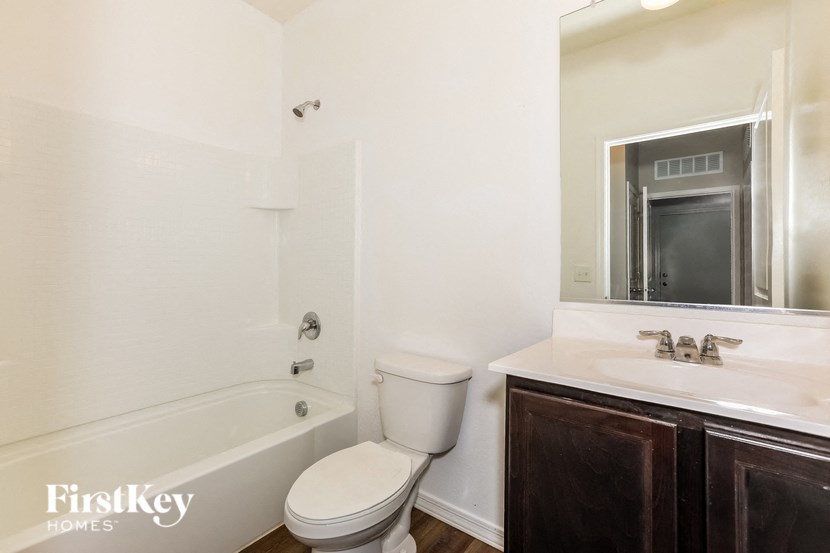 a bathroom with a toilet and a sink and a bath tub
