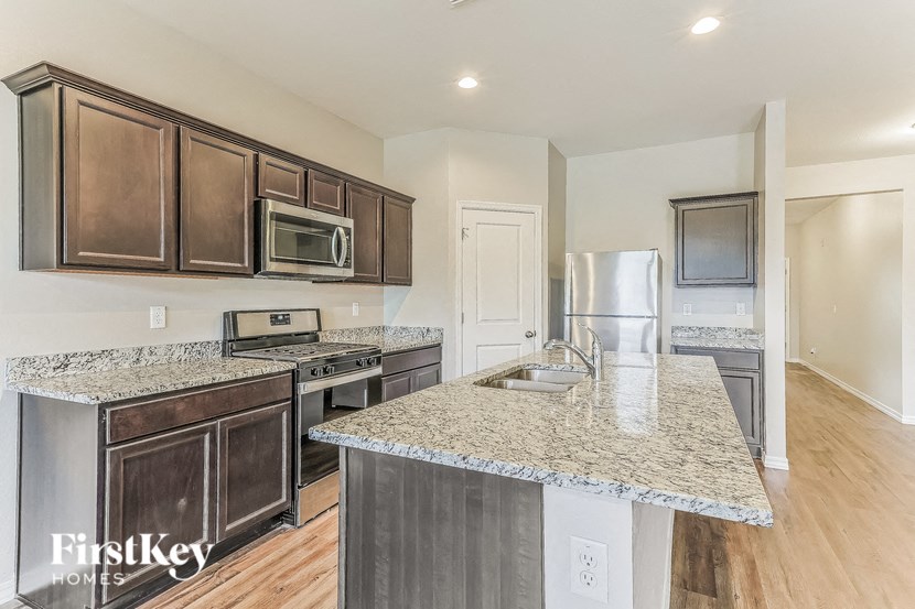 a kitchen with granite counter tops and stainless steel appliances