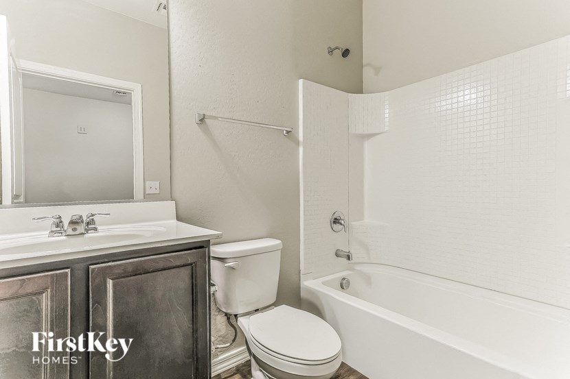a bathroom with a toilet and a sink and a tub
