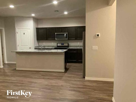 a kitchen with black cabinets and a counter top