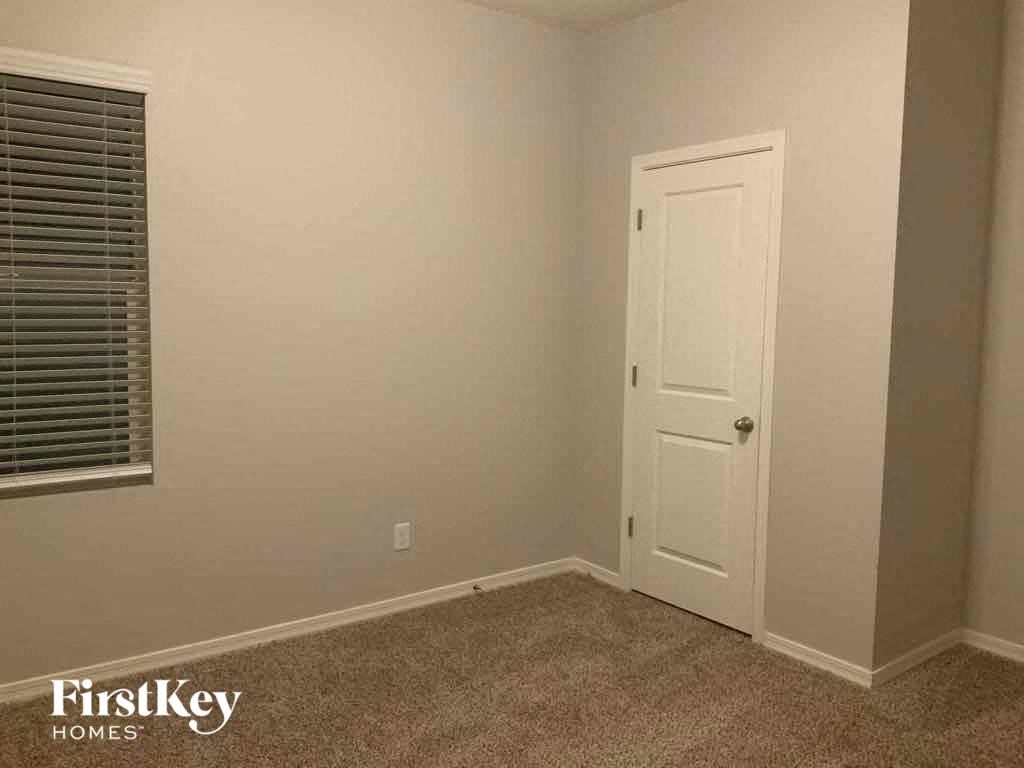 a small room with a white door and a window