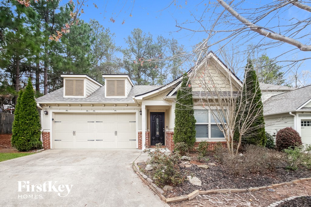a home with a white garage door in front of it