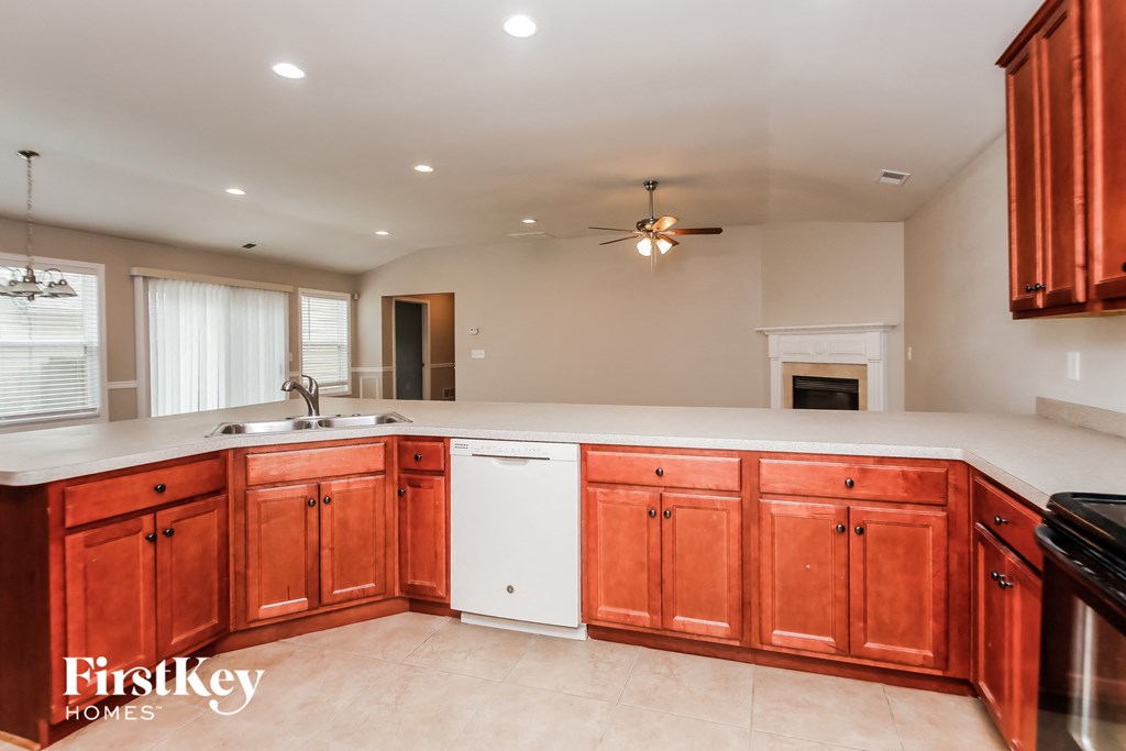a kitchen with wooden cabinets and a white counter top