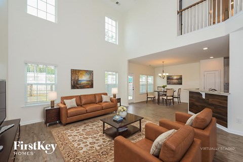 A living room with a brown couch and a coffee table.