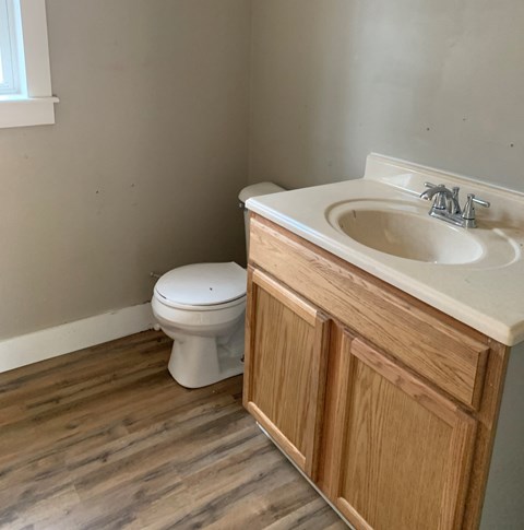 an empty bathroom with a sink and a toilet