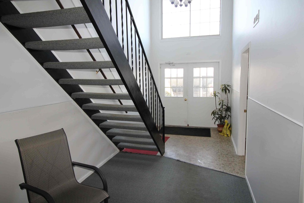 A chair is in front of a staircase.