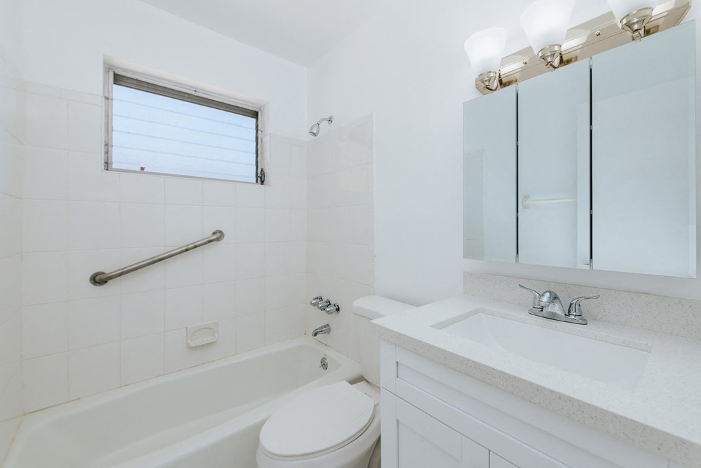 a bathroom with a sink toilet and a bath tub