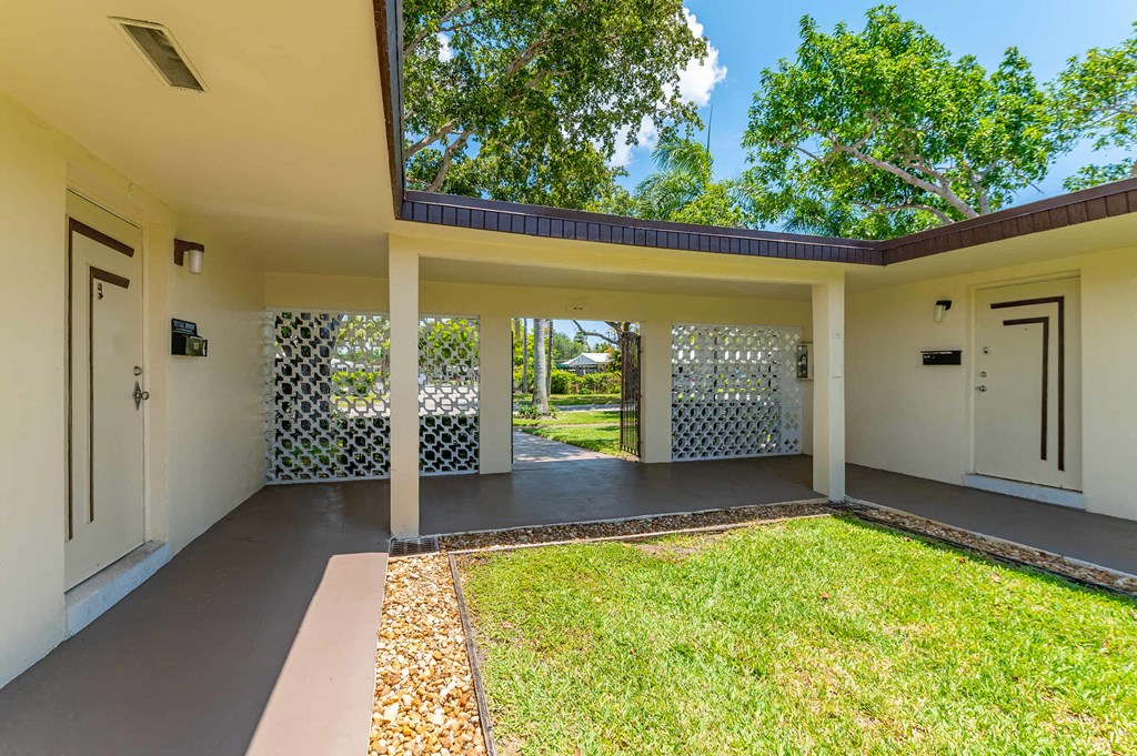 a large white house with a yard and a door