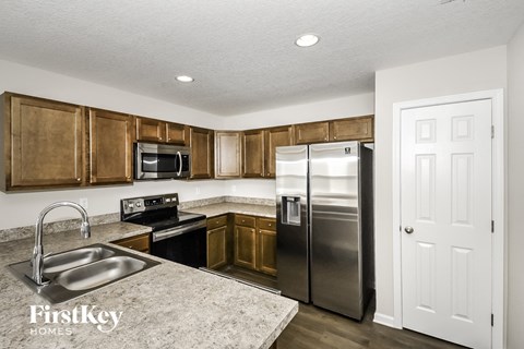 a kitchen with stainless steel appliances and wooden cabinets