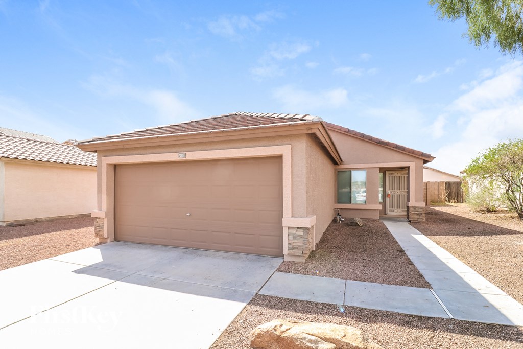 A house with a brown garage door and a brown roof.
