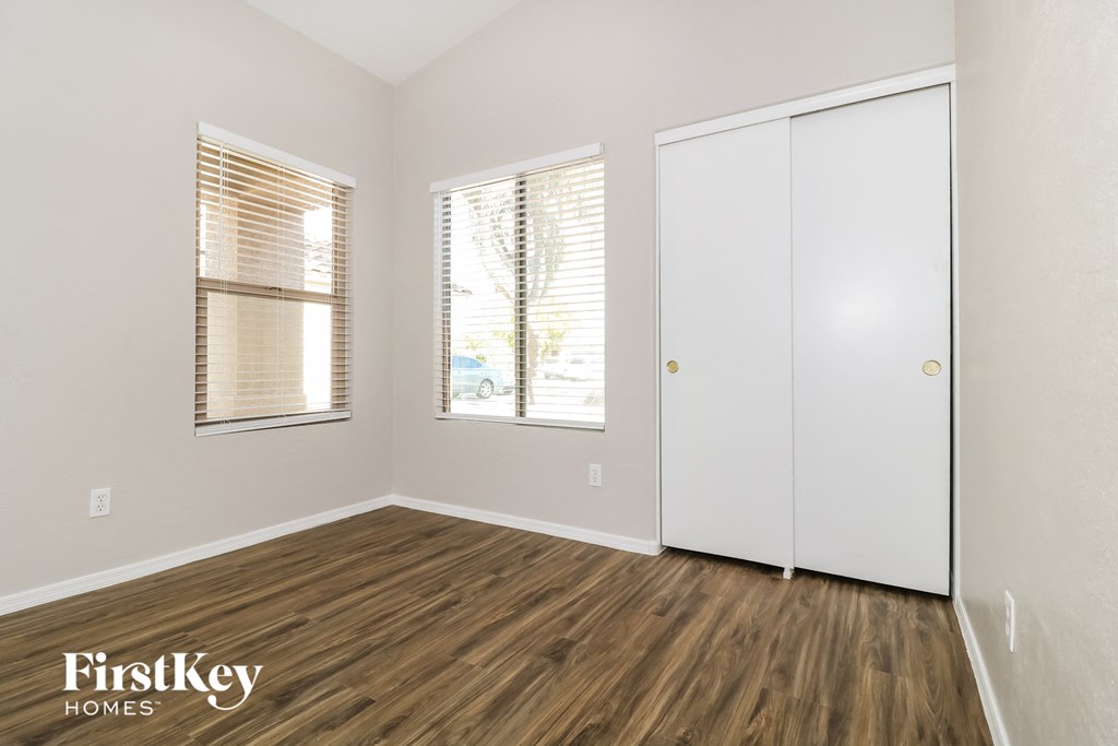 A room with wooden floors and a white closet.