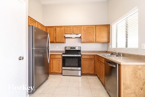 A kitchen with wooden cabinets and stainless steel appliances.