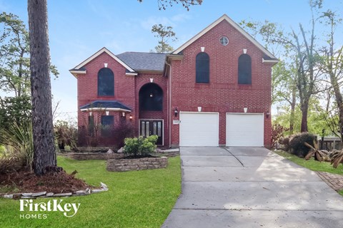a red brick house with a white garage door