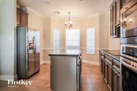 a kitchen with stainless steel appliances and a large island