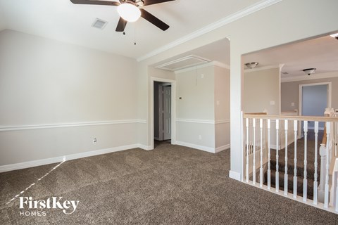 a nursery with a crib and a ceiling fan