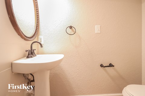 a bathroom with a sink and a mirror and a toilet