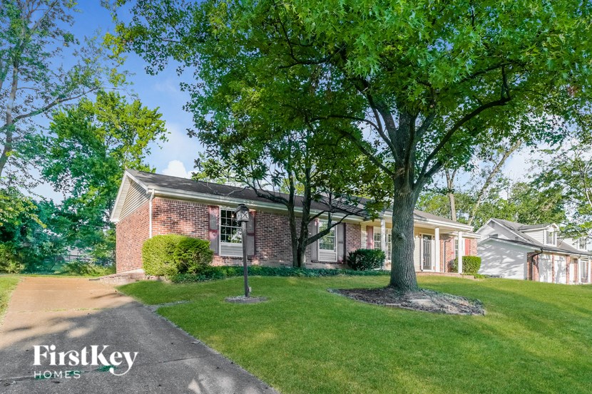 a brick house with a tree in front of it