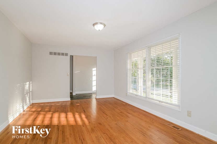 a living room with wood floors and a large window