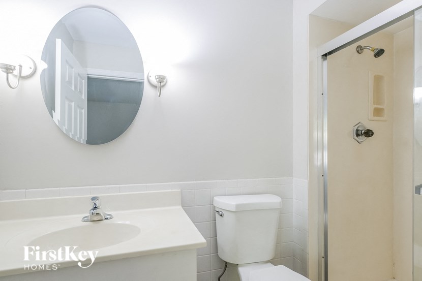 a bathroom with a toilet and a sink and a mirror