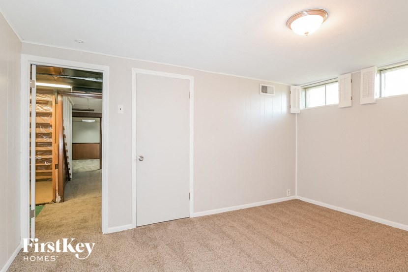 a bedroom with a closet and a door to a hallway
