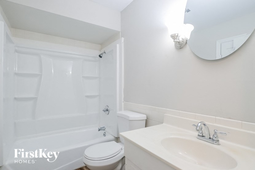 a white bathroom with a sink toilet and bath tub